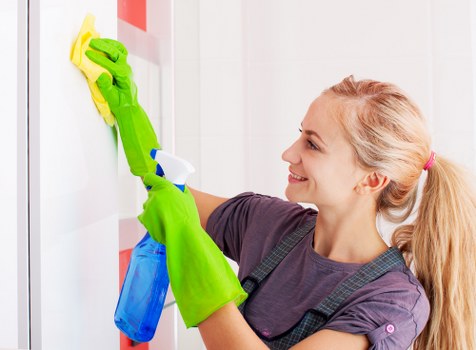 Commercial cleaner preparing an office workspace in SW10