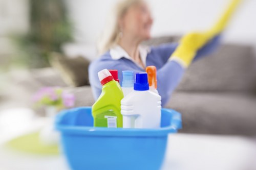 A move-in cleaning team working through cupboards, surfaces, and floors in a local SW10 flat